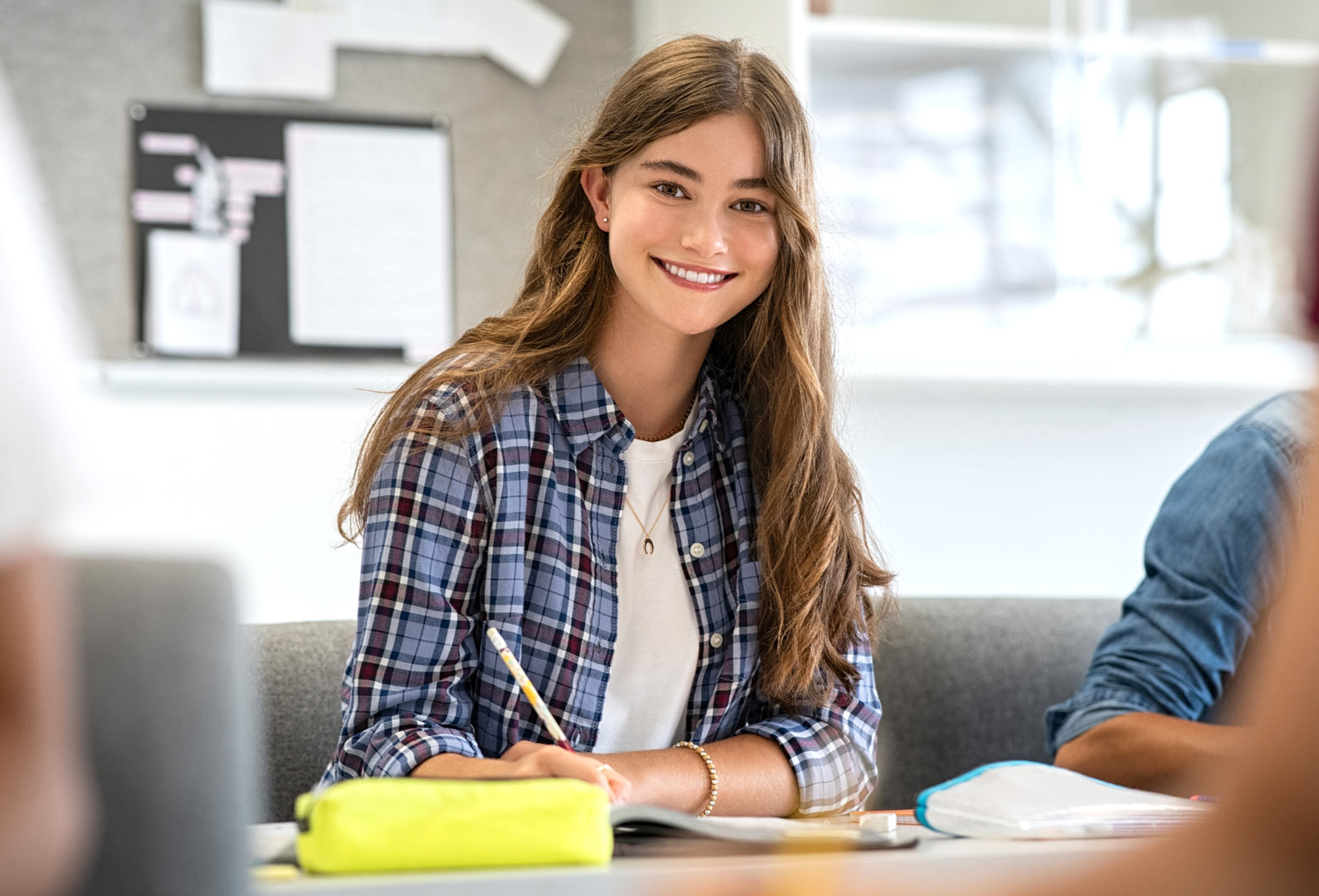 College student takes notes at a desk